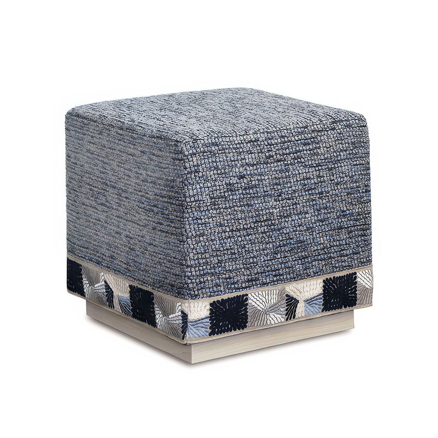Blue cube ottoman on white background, corner view.