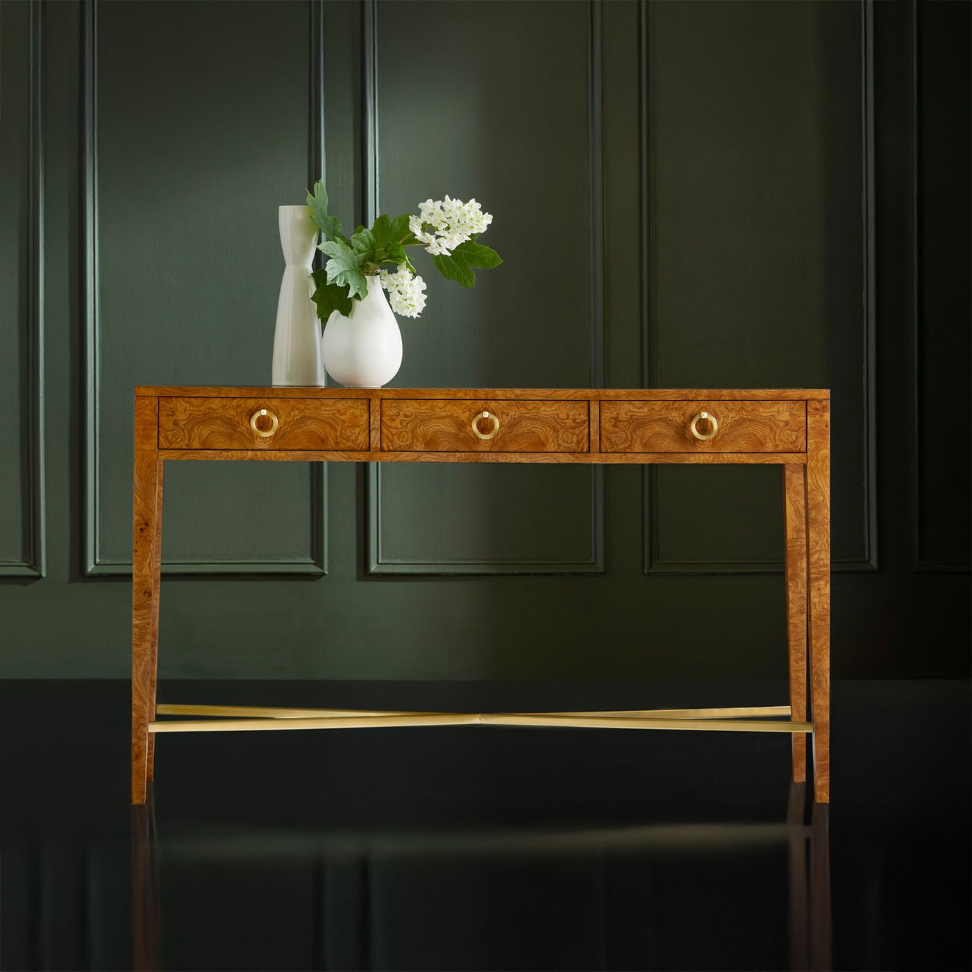 Console table with decor, dark background, elegant design.