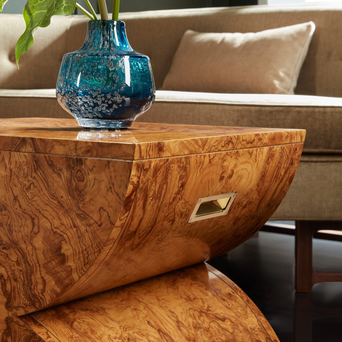 Close-up of Olive Ash Burl accent table with vase.