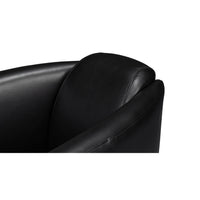 Black leather club chair, top armrest detail.