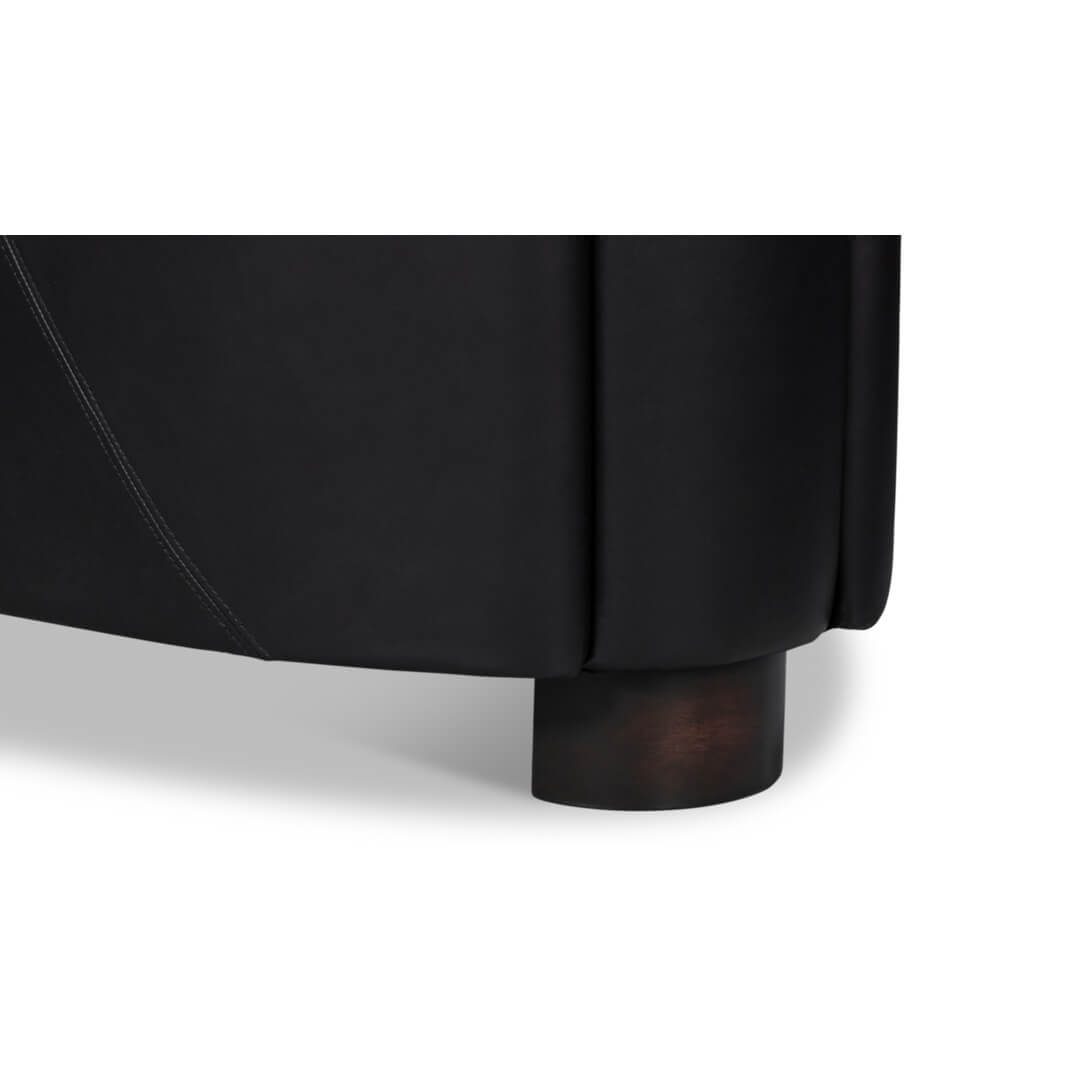 Black leather club chair, leg detail view.