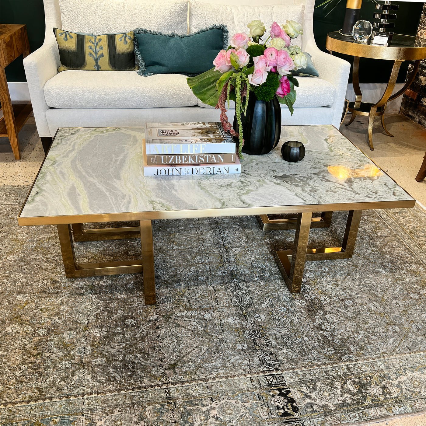 Coffee table in cozy room, decorated with books and flowers.