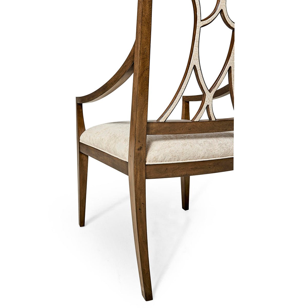 Side view of wooden armchair detailing open lattice back.