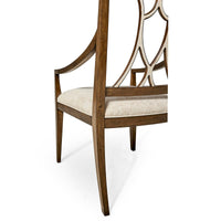 Side view of wooden armchair detailing open lattice back.