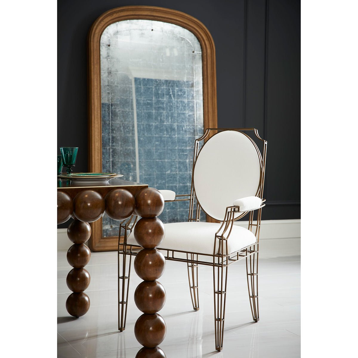 Openwork steel arm chair in modern dining setting.