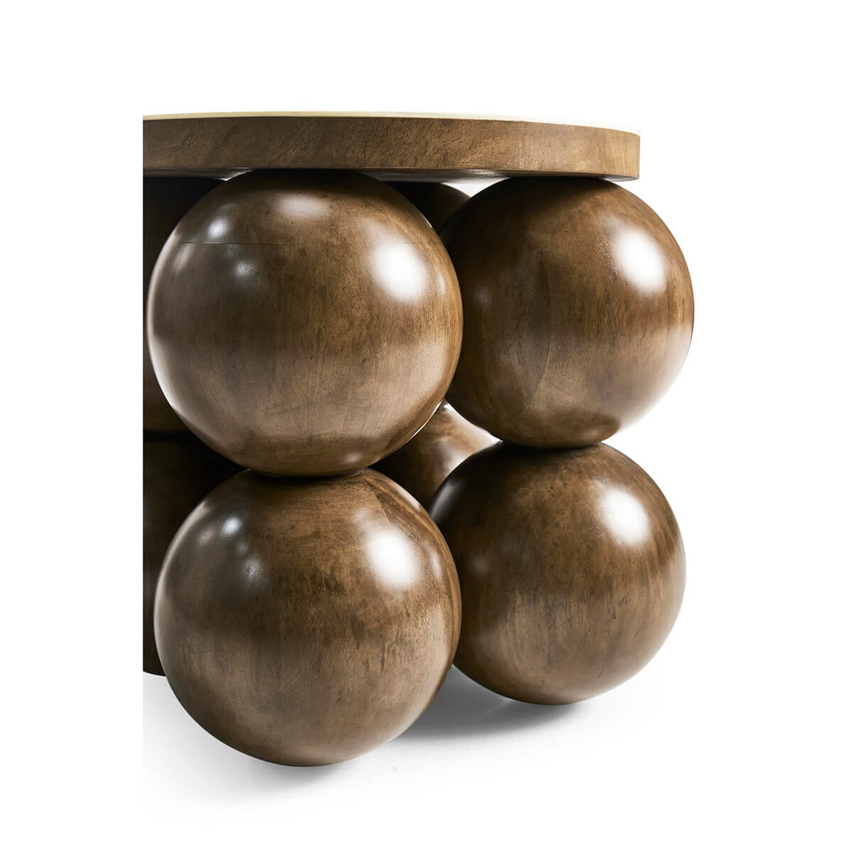 Close-up of spherical bases on wood accent table.