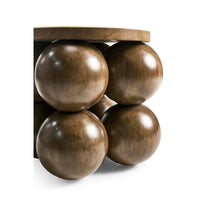 Close-up of spherical bases on wood accent table.