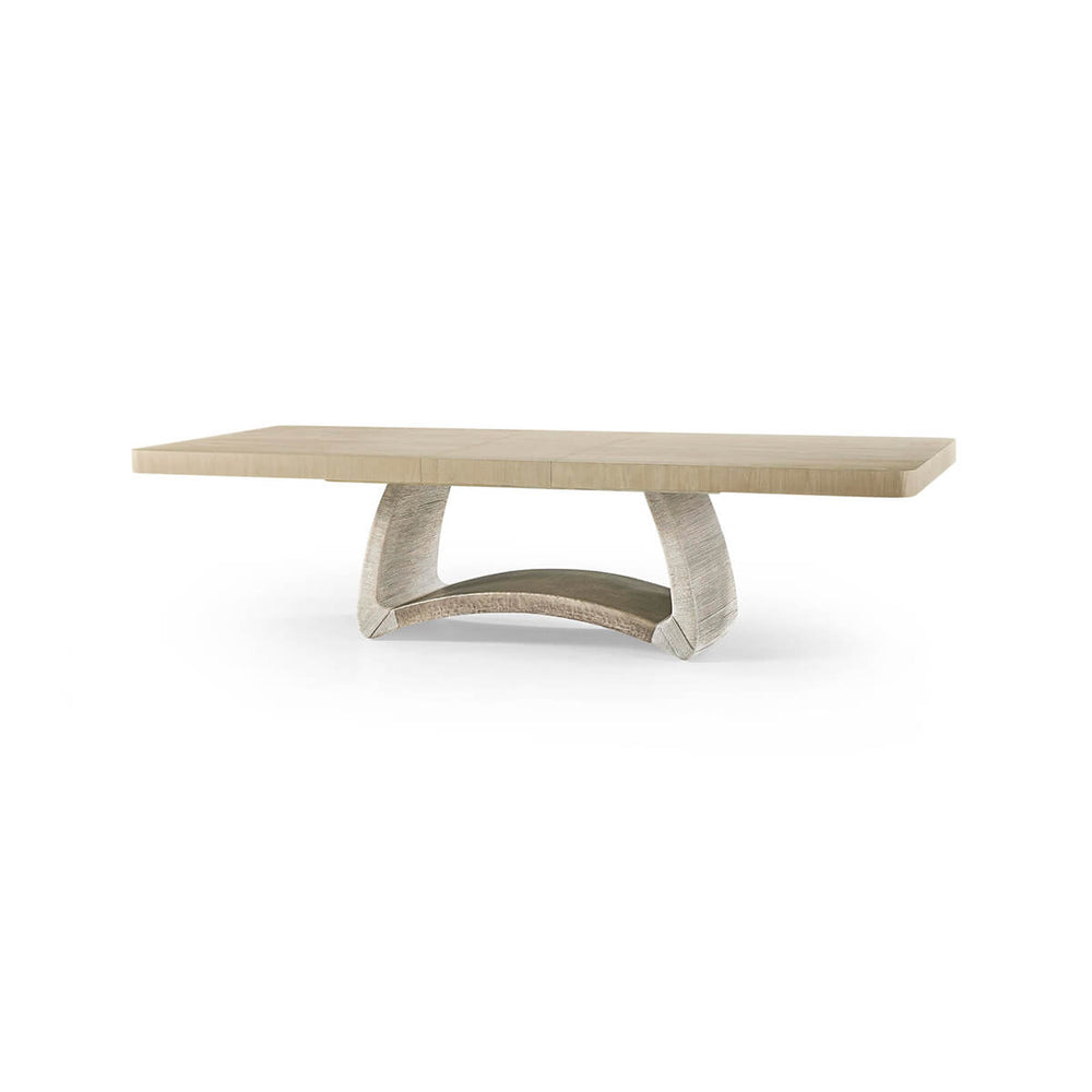 Dining table with modern curved base, side view.