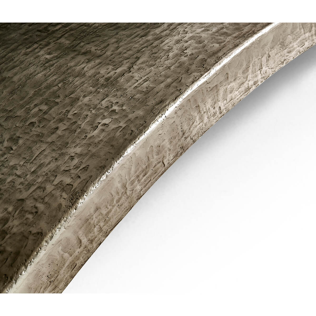 Close-up of dining table metallic curve detail.