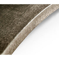 Close-up of dining table metallic curve detail.