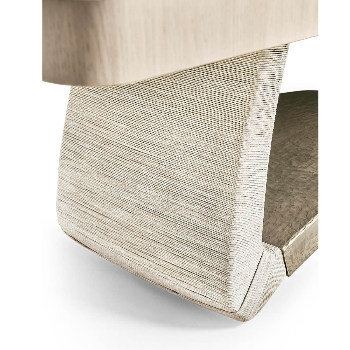 Dining table base with textured surface, close view.