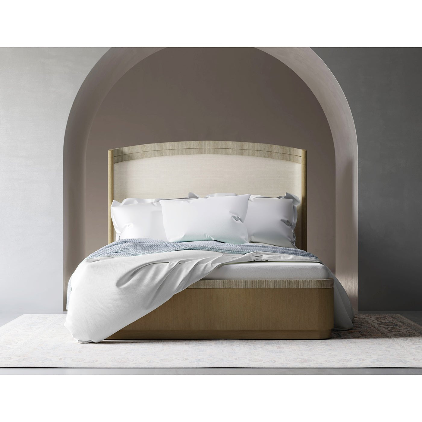 Organic king bed with draped bedding, archway backdrop.
