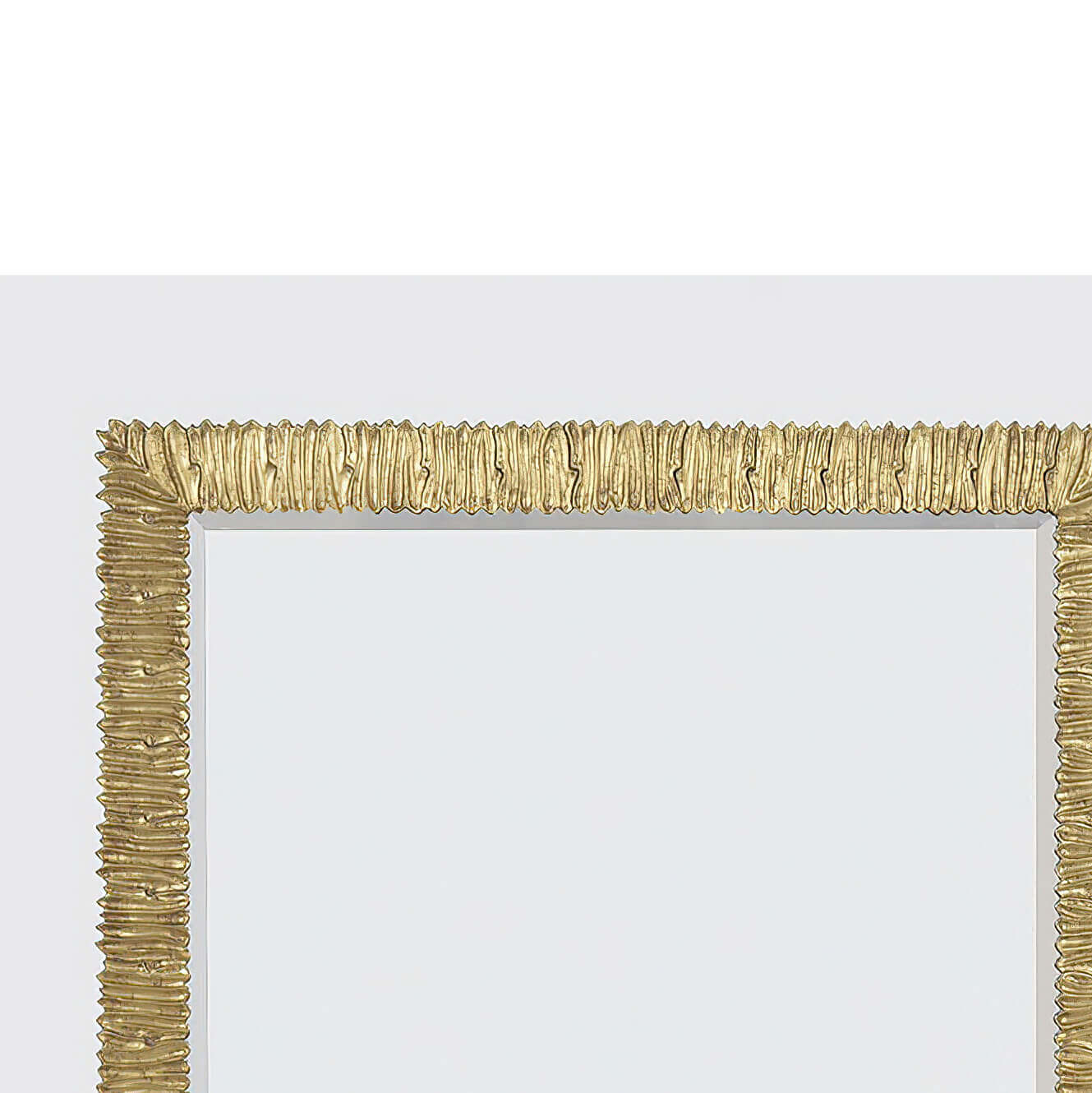 Close-up of gilt mirror's ornate gold frame edge.