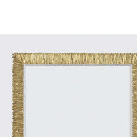Close-up of gilt mirror's ornate gold frame edge.