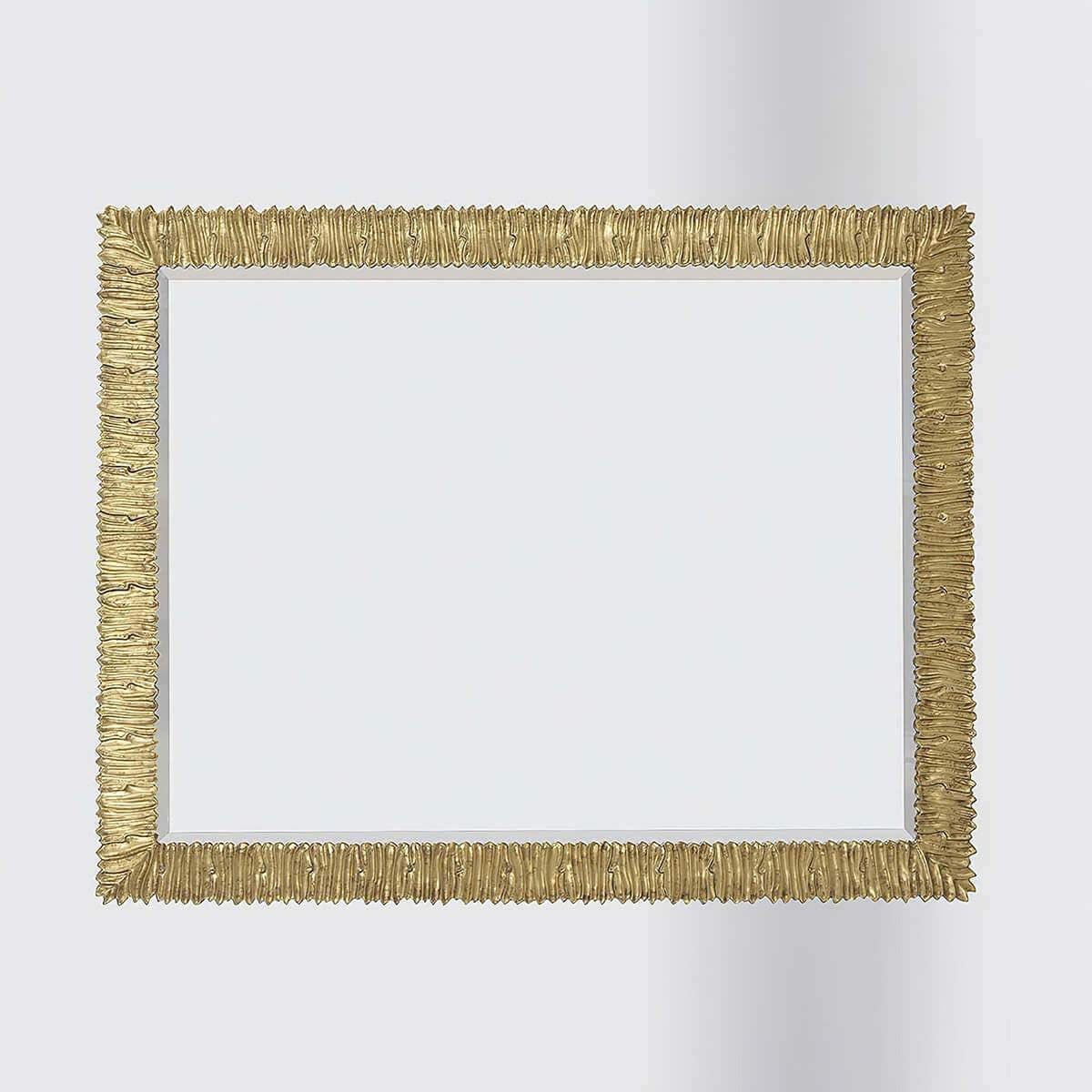 Horizontal gold-framed mirror centered against plain backdrop.