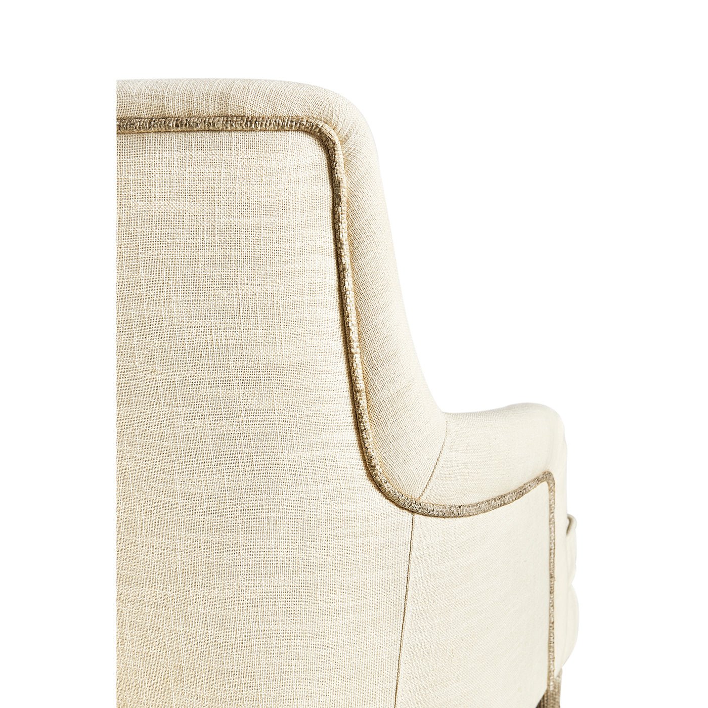 Cream linen armchair, close-up of backrest and piping.
