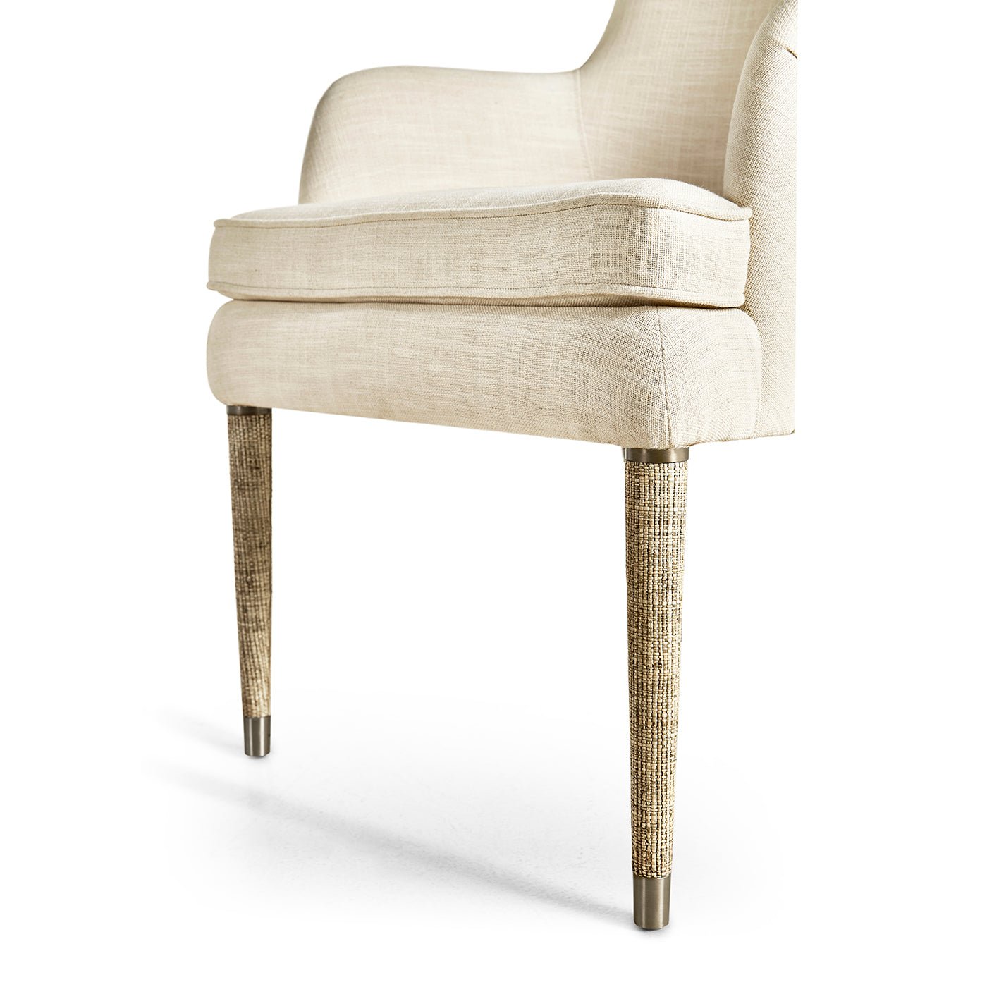 Cream linen armchair, focus on wooden legs and seat.