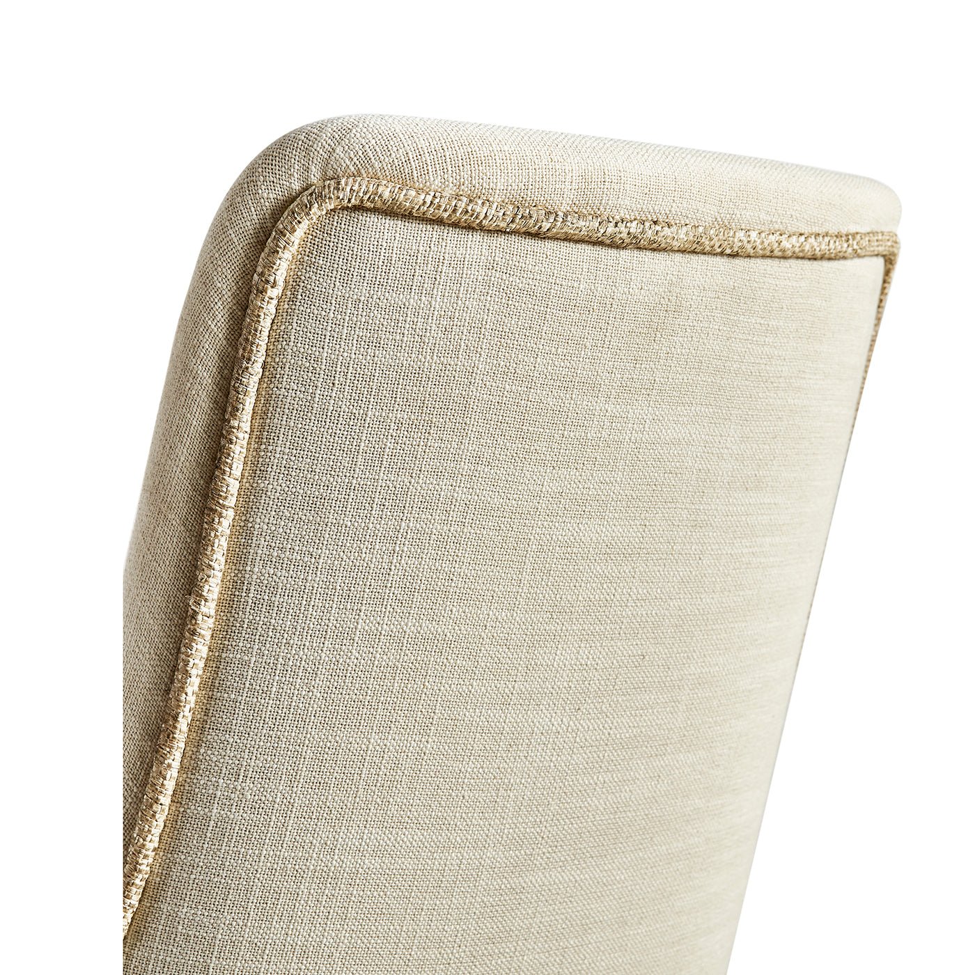 Detail of the top back of beige dining chair.