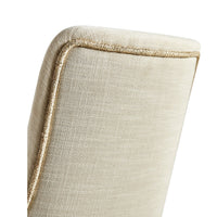 Detail of the top back of beige dining chair.