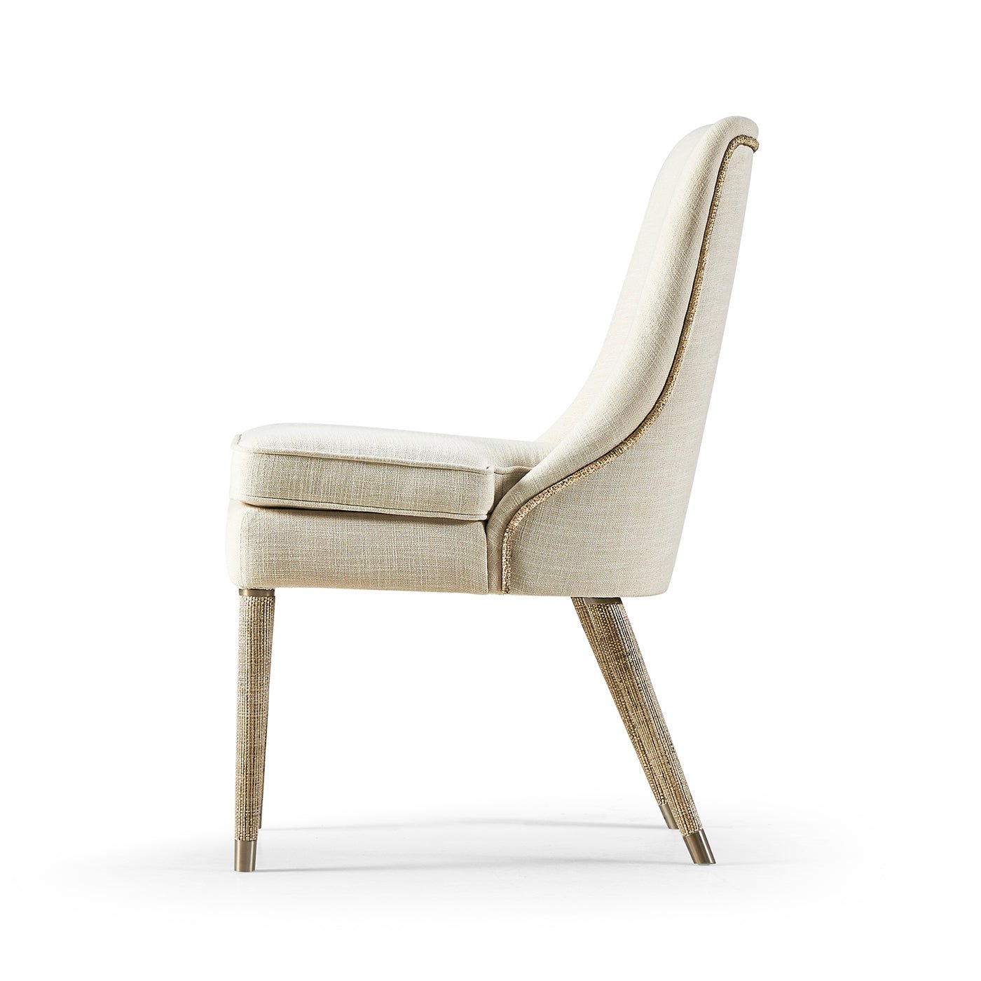 Side profile of beige upholstered dining chair.