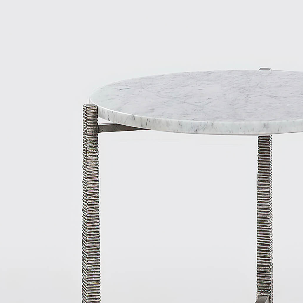Close-up of marble side table edge and support details.