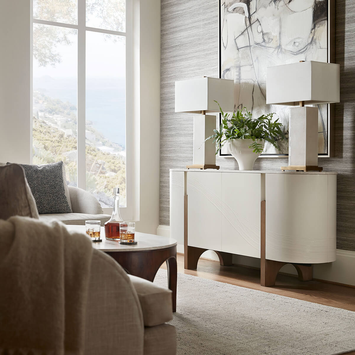 Media cabinet in living room setting with decor and lamps.