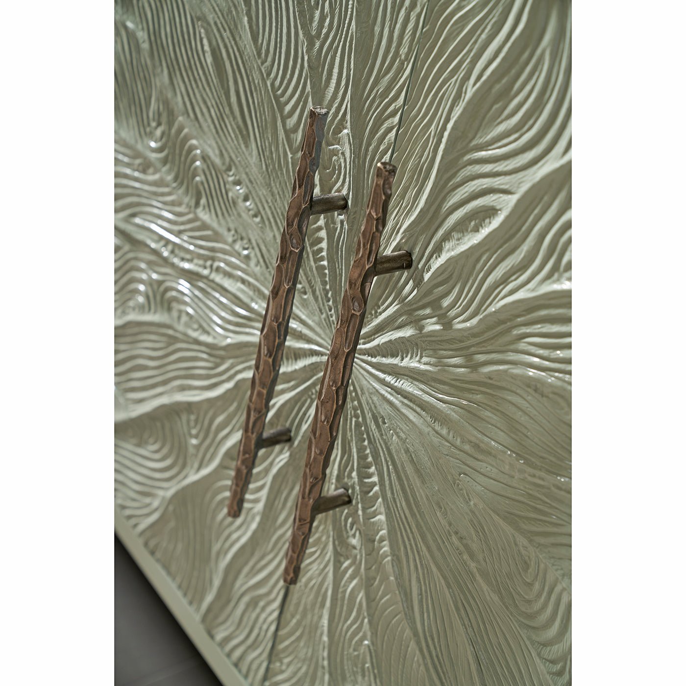Intricate textured handles on media cabinet doors.