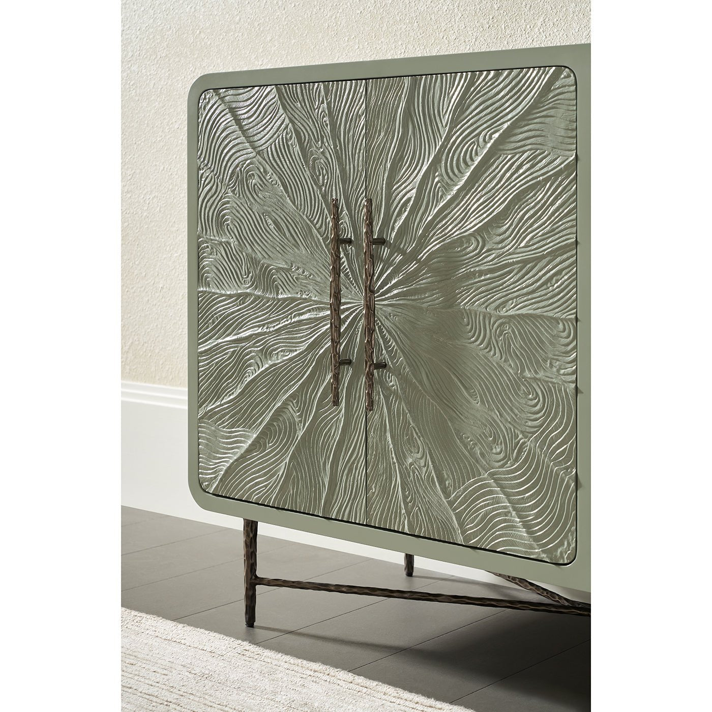 Textured media cabinet corner detail with metal handles.
