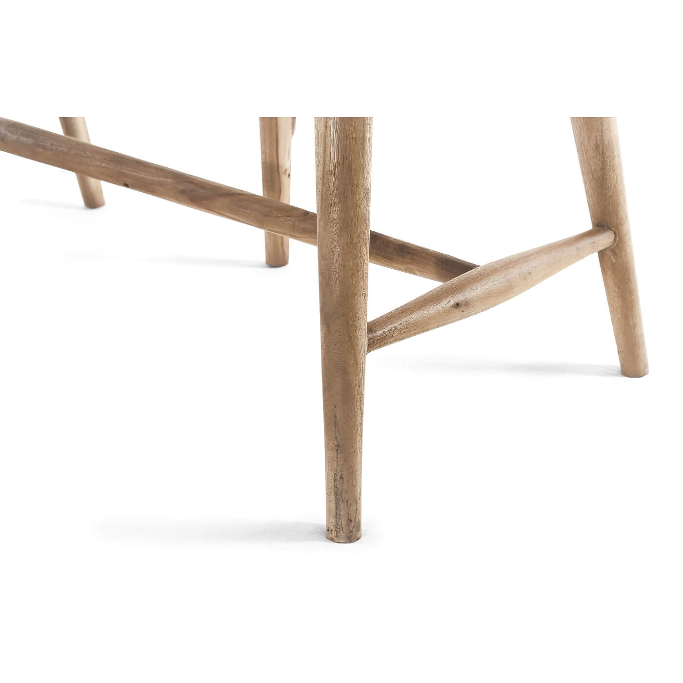 Close-up of legs on natural wood bench.
