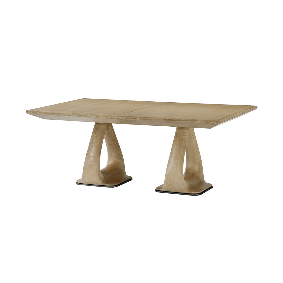 Angled view oak extending dining table on dual pedestals.