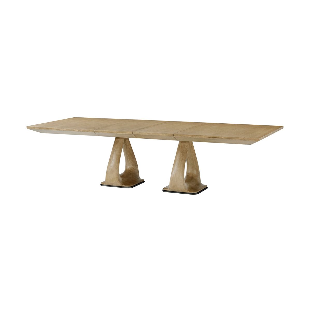 Long view oak extending dining table with pedestal bases.