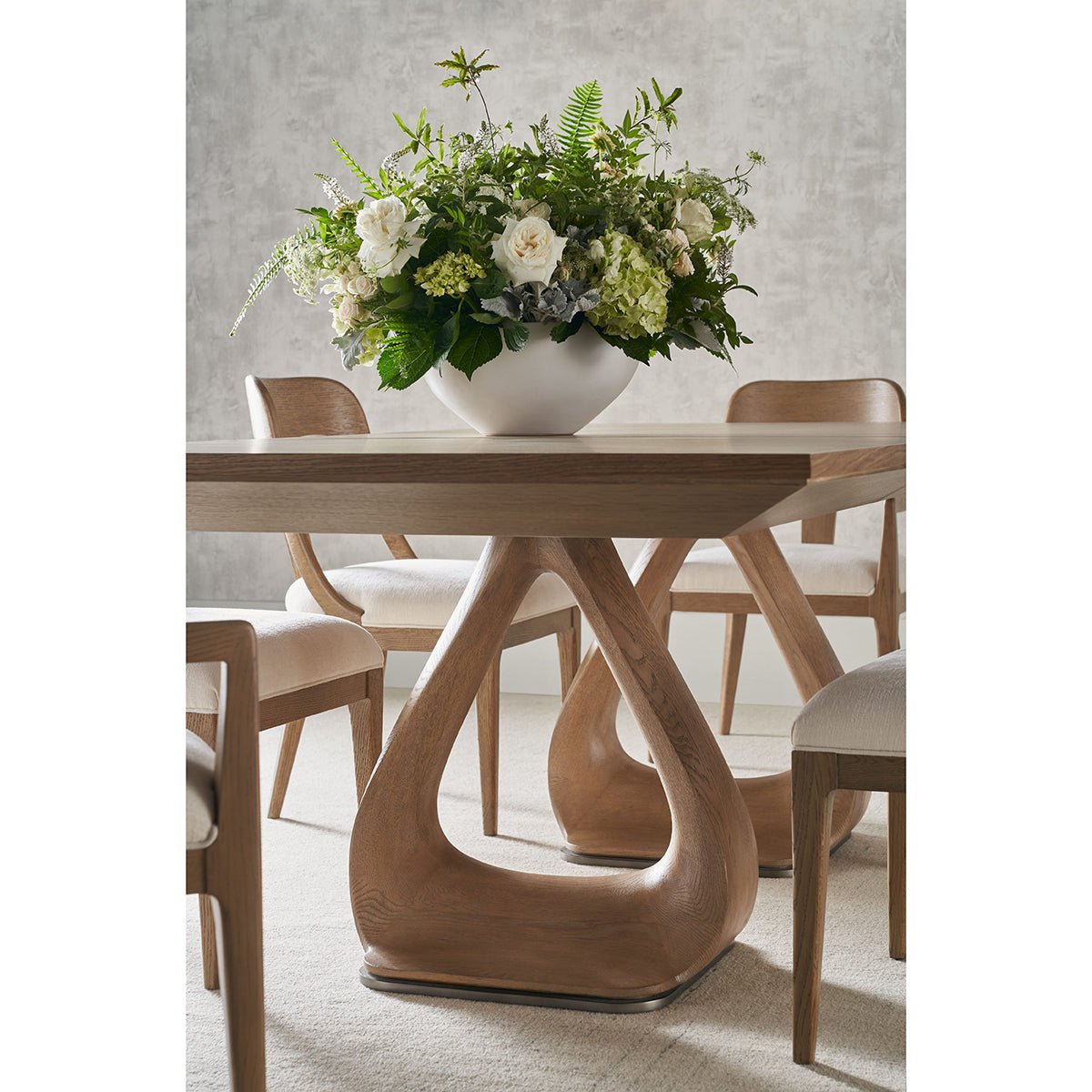 Floral centerpiece on oak extending dining table.