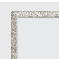 Detailed corner view of silver framed mirror.