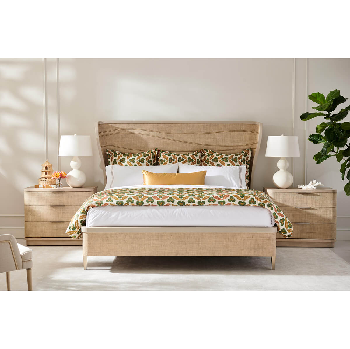 Organic modern king bed styled with pillows and nightstands.