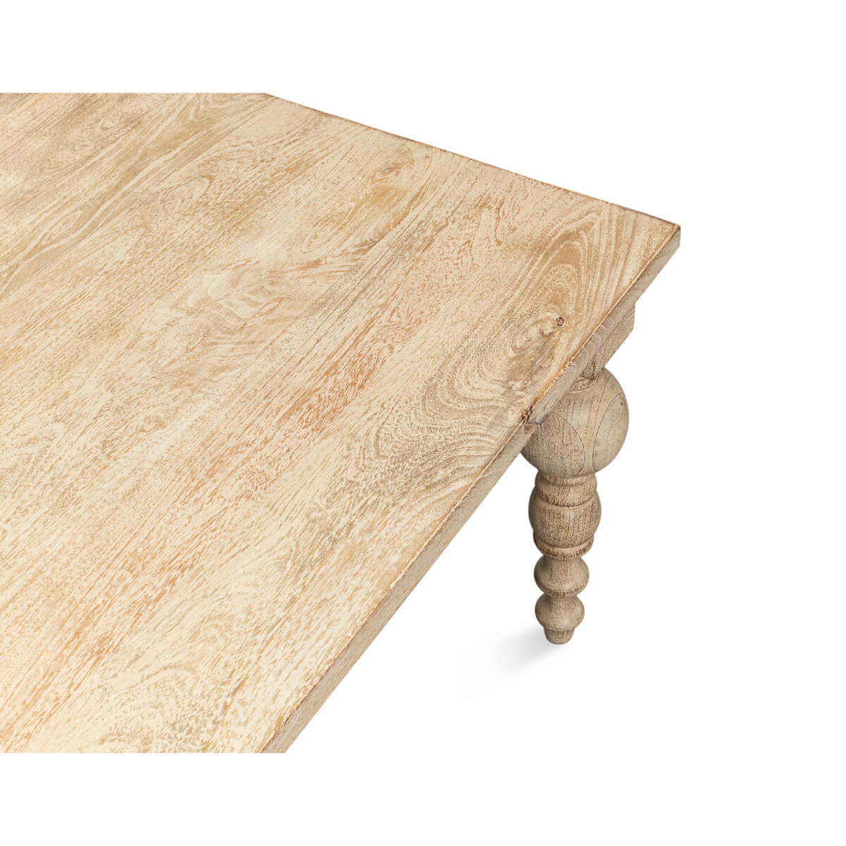 Corner perspective of coffee table showing wood grain and leg.