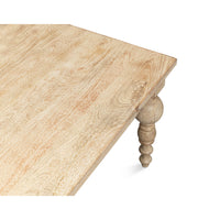 Corner perspective of coffee table showing wood grain and leg.