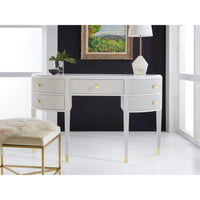 Art deco console in styled room with artwork and lamp.