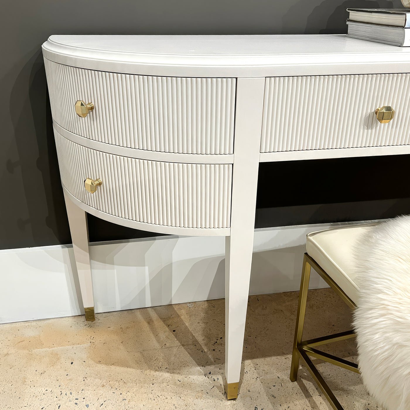 Close-up of console vanity's curved drawer detailing and legs.
