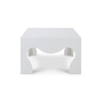 Side profile of white coffee table with wave cutouts.