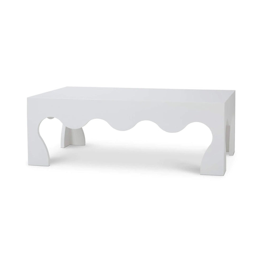 White modern coffee table with wavy cutout design.
