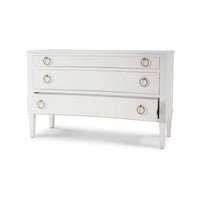 Partially open drawer of white classic incurved commode.