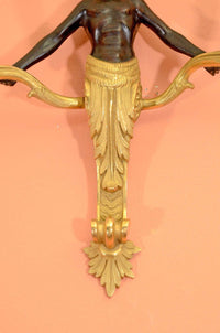 Detail of bronze sconce's ornate lower design.