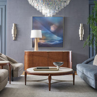 Living room with lamp, artwork, and chandelier.