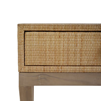 Close-up of nightstand drawer corner, rattan texture.