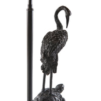 Side view of crane detail on table lamp.