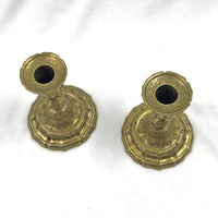 Top view of ornate French brass candlesticks.