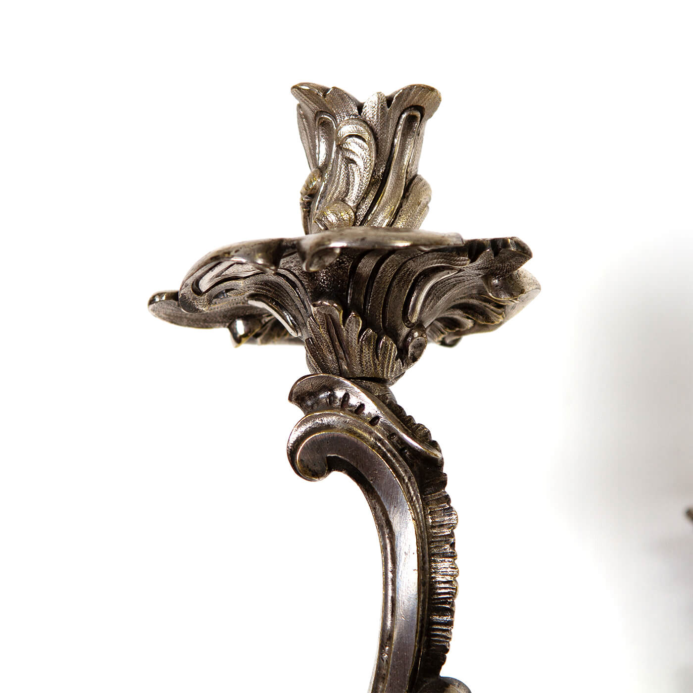 Elegant candle holder on French Chinoiserie sconce, intricate design.