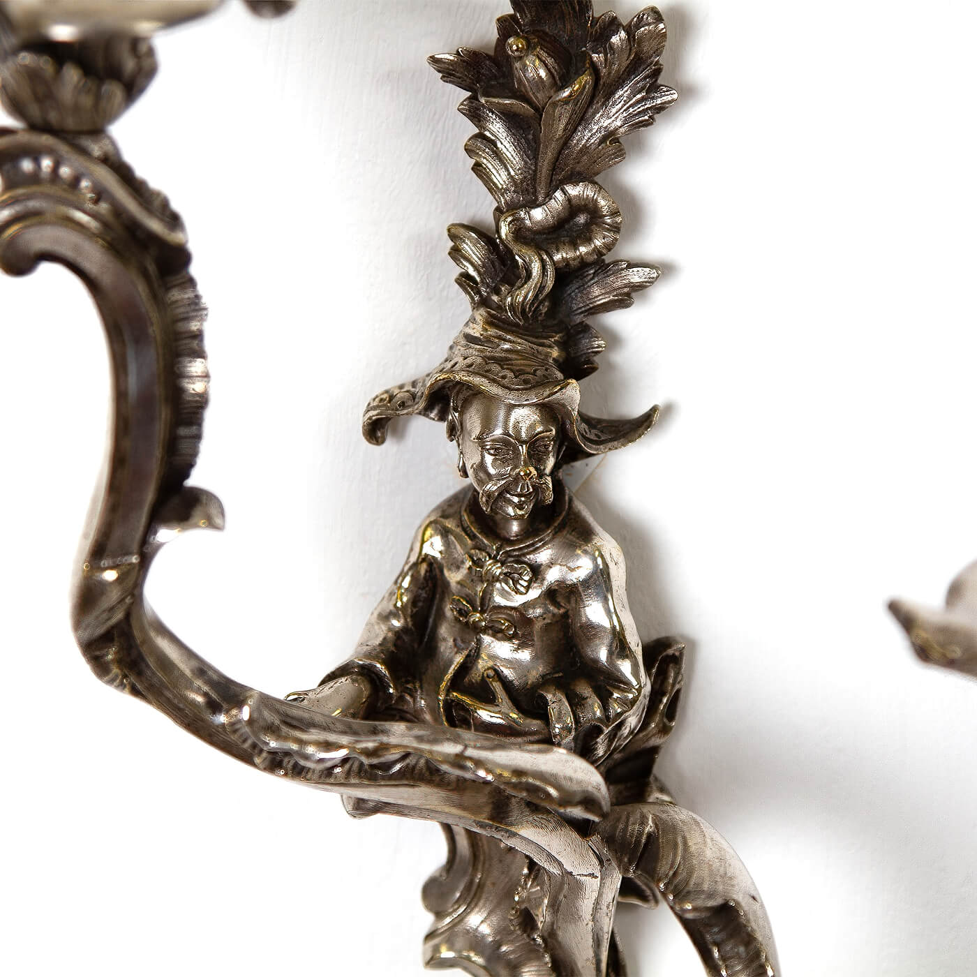 Sculpted figure and details on French Chinoiserie sconce.
