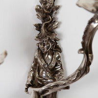 Detailed figure on French Chinoiserie sconce, artistic craftsmanship.