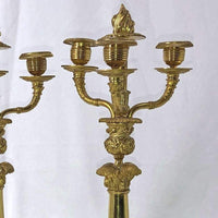 Close-up of detailed gold branches on French candelabra.